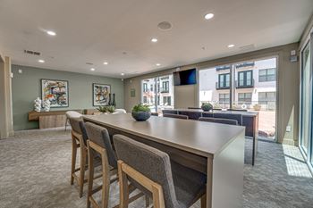 Resident lounge with community bar and outdoor terrace